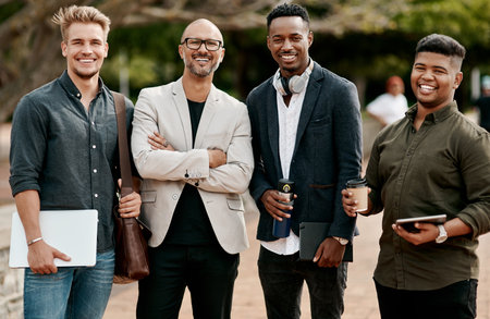 Meet the team to beat. Portrait of a group of businessmen having a meeting against a city background.の写真素材