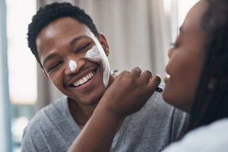 More glow, less gender roles. a young couple getting homemade facials together at home.の写真素材