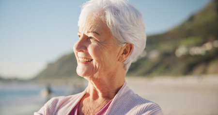 Senior woman, smile and sunset on beach to relax with peace outdoor in nature, sea and elderly...