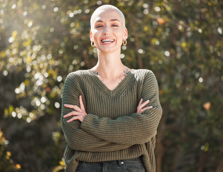 Be your own reason to smile. Cropped portrait of an attractive young woman standing with her arms folded outdoors.の写真素材