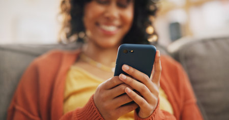 Home phone, hands or happy woman relax, smile and typing online search, customer experience review and check app. Living room couch, smartphone scroll or person reading blog, article or communicationの写真素材