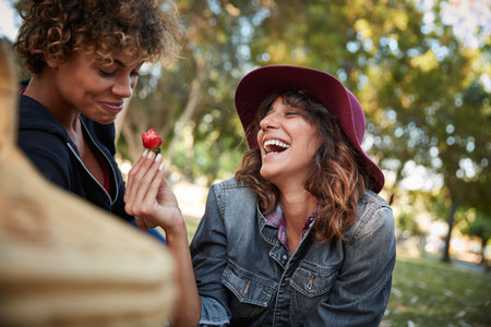 Take another bite of the love fruit. a young couple spending the day outdoors on a sunny day.の写真素材