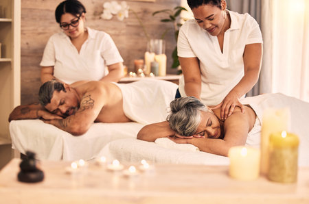 Massage, senior and a couple at the spa to relax on their anniversary together for peace, wellness or bonding. Luxury, beauty or body care with an old woman and man in a salon for physical therapyの写真素材