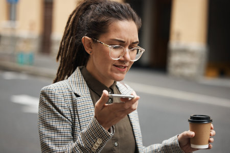 Business woman on voice message in a city to travel or commute in the morning with coffee talking to...