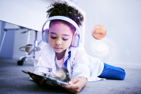 Child, science and astronomy on tablet with web education and internet app for kids. Home, child and digital holograph of space and planets with headphones listening to children research podcastの写真素材