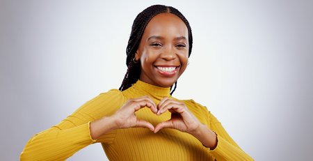 Heart, hands and portrait of woman in studio for kindness, icon and charity donation on white...