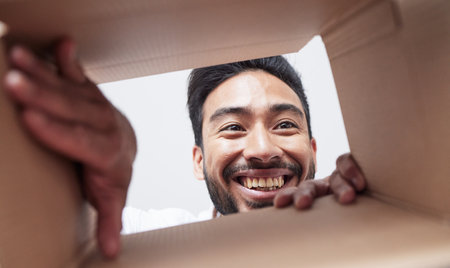 Open, delivery or happy man with box, gift or package with smile for courier service or ecommerce. Face, wow or customer excited by mail post order, parcel cargo or online shopping shipping presentの写真素材