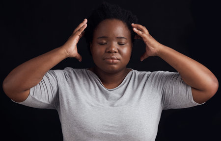 Frustrated black woman, stress and anxiety in studio with fear of crazy memory, trauma or noise in...
