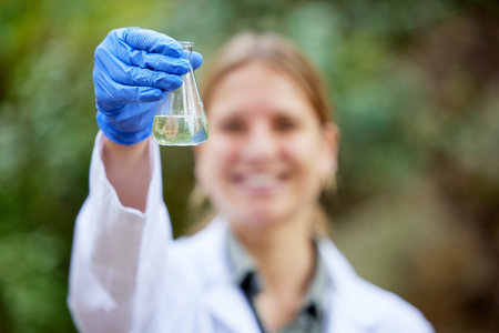 Forest, sample and professional scientist test water for research or inspection of the ecosystem and...