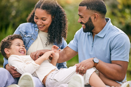 Tickle, relax and happy with family in garden for playful, bonding and love. Happiness, relax and smile with parents and child playing in backyard of home for free time, care and laughing togetherの写真素材