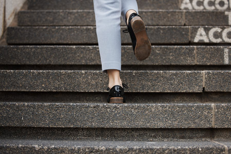 Closeup, shoes and person walking up stairs, travel and fancy with formal outfit, career and...
