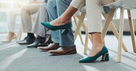 Closeup, business people and shoes with feet, job interview waiting room and nervous with opportunity. Row, group and candidates with recruitment with heels, footwear and hiring in a workplaceの写真素材