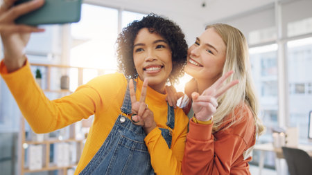 Girl friends, happy and selfie in home with peace sign and social media photo for post at home. Smile, profile picture and friendship of young women together in a living room with funny hand gestureの写真素材