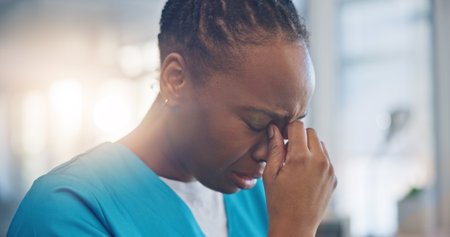 Black woman, nurse and crying, sad and mental health with depression, help and psychology with stress at work. Fatigue, healthcare and burnout with mistake, fail with reaction to news and overwhelmedの写真素材