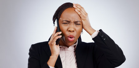 Phone, business woman and angry from scam conversation and anxiety from problem and fail. Studio, white background and frustrated female person with spam communication and identity theft mistakeの写真素材