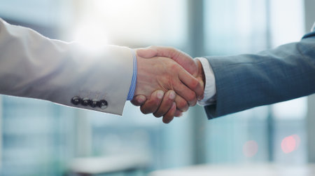 Business people, collaboration and shaking hands for agreement, deal and praise for success, welcome or reward. Closeup, handshake and introduction of partnership, support integration and negotiationの写真素材