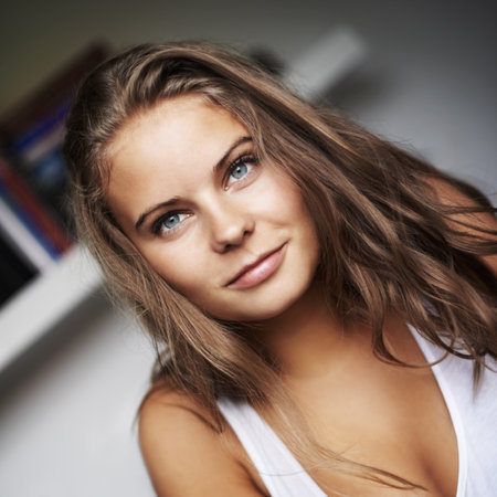 Happy, woman closeup and portrait with smile and modern clothing in a house with confidence. Youth, teen and relax young female person from New York with gen z style and modern clothes in a houseの写真素材