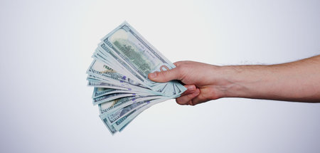 Hand, payment and closeup of cash in a studio for retail shopping, paying bills or debt. Mockup,...