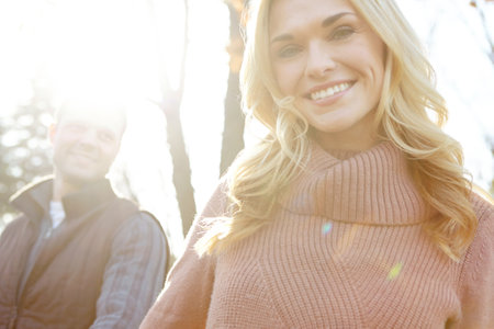 Leading the way through the woods. A happy and loving couple spending time out in the woods together.の写真素材
