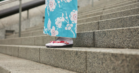 Feet, stairs and person in Japanese kimono for travel, tourism or Tokyo sightseeing closeup. Sandals, steps and culture with tourist outdoor in clothes for tradition, vacation or holiday adventureの写真素材