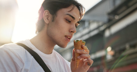 Ice cream, eating and Japanese man in city on vacation, holiday and adventure in Yokohama town....