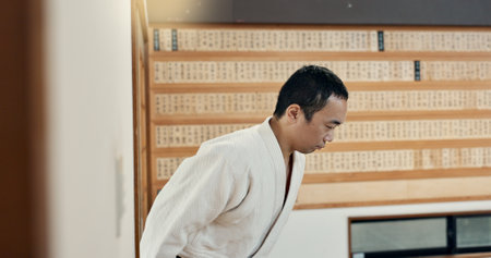Bow, karate or people in dojo for martial arts for fitness, discipline or self defense for respect or honor. Kung fu, workout or Asian men walking in training for fighting, wellness or combat sportsの写真素材