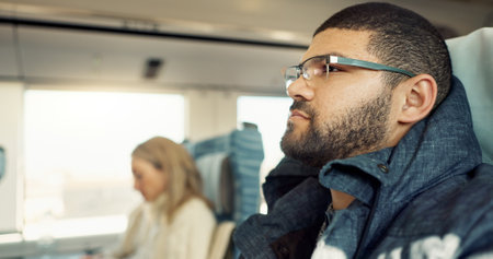 Thinking, idea and young businessman on a train for public transportation to work in the city. Reflection, planning and professional male person from Mexico commuting to office in urban town.の写真素材