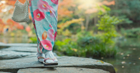 Walking, lake or legs of woman in nature for journey on holiday vacation for freedom or wellness. Park, travel or feet of Japanese person on rocks for health, peace and inspiration to relax in forestの写真素材