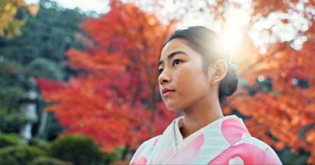 Woman in park, Asian and peace, thinking about life with reflection and tranquility in traditional clothes. Travel, Japanese garden and nature for fresh air, inspiration or insight with floral kimonoの写真素材