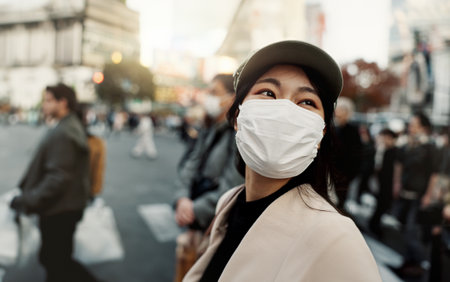 City, japan and woman in travel with face mask for health and walking in town. Covid compliance, safety for wellness and female person outdoors with facial protection for corona virus pandemicの写真素材