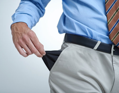 Businessperson, empty pocket and poverty in studio, unemployment and bankruptcy by white background. Closeup, no money and financial trouble or bad investment, stock market crash and poor or brokeの写真素材