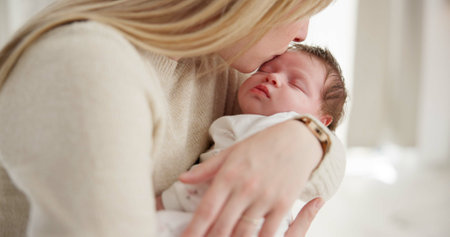 Family, kiss and a mama rocking her baby to sleep in the bedroom of their home together for love or care. Dreaming, nap or tired with a parent and newborn infant in an apartment to rest for growthの写真素材