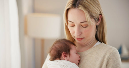 Newborn, love and mother with baby for sleeping, bonding and child development together at home. Family relationship, motherhood and mom carry infant for care, support and dreaming in nursery roomの写真素材