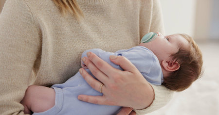 Mother, relax baby and nap with love, care and support for newborn in nursery with sleep. Young...