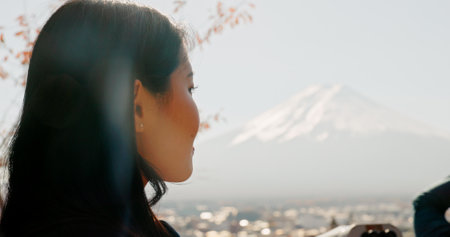 Japanese woman, thinking and nature for mountain, travel and outdoor on vacation, trip or journey. Girl, person and holiday by Mt Fuji with vision, memory or ideas in closeup, environment and treesの写真素材