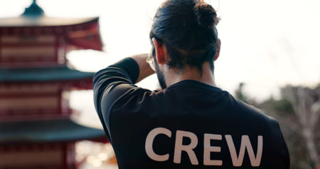 Photography, man and working crew from the back in Japan shooting with camera for travel at a...