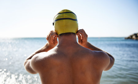 Sports, ocean and back of man for swimming exercise, workout or training in beach, nature or water....