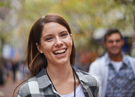 Smile, walking and portrait of woman on city journey, morning trip and tour of urban Paris for outdoor adventure. Wellness, happiness or face of bonding people, partner or girlfriend on relax commuteの写真素材
