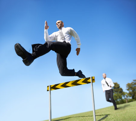 Businessman, hurdle and jumping for career competition or employee obstacle, opponent or achievement. Male people, corporate rivals and leap for professional growth or challenge, milestone or mockupの写真素材