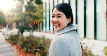 Walking, city and Japanese business woman with smile for morning commute, journey and travel to work. Professional, corporate and portrait of happy person in urban town for career, working and jobの写真素材