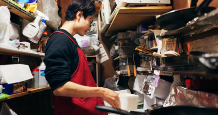 Japanese chef man, cooking and kitchen by stove, service or catering job on pan, pot and ready. Person, restaurant or cafeteria with chopsticks for meal prep, working or thinking for recipe in Tokyoの写真素材