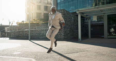 Senior business man, dancing and street for celebration, goals or happy with career achievement. Elderly African entrepreneur, CEO or dancer with moving, steps or smile for profit at job in Cape Townの写真素材