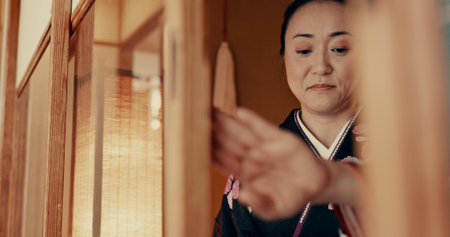 Japanese, woman and kimono in corridor or tradition in chashitsu room with indigenous fashion or clothing. Person, ritual and ceremony for temae, wellness and zen in architecture building in Tokyoの写真素材