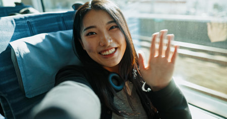 Train, selfie and portrait of woman wave in city for travel, commute and journey on metro transportation in town. Passenger, railway and face of happy person take picture on trip in public transportの写真素材