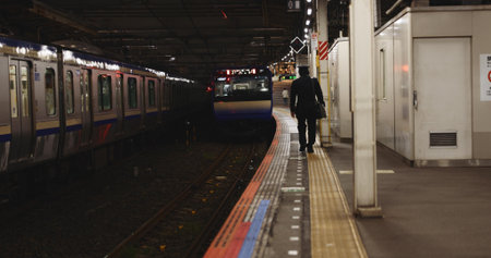 Train, platform and man at station for travel, commute or journey on railway transportation. Public...