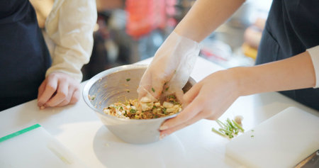 Chef hands, cooking and food in restaurant with bowl, vegetables and prepare ingredients for nutrition. People, working and catering service for diet at cafeteria with meal, dinner or lunch on tableの写真素材
