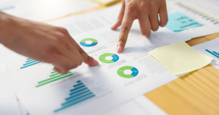 Hands, business people in meeting and data analysis, review paperwork with graphs and info, team...