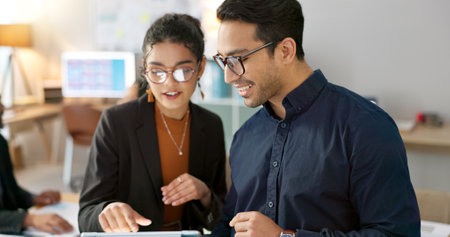 Office, business people and brainstorming with planning, tablet and teamwork with internet, connection and cooperation. Staff, man and woman with technology, digital app and collaboration with ideasの写真素材