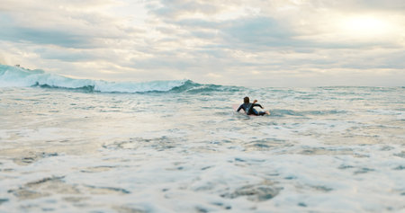 Surfing, ocean and woman with waves on surfboard for water sports, fitness or freedom by beach....