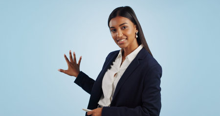 Business woman, portrait and presentation of anchor in advertising on a blue studio background....